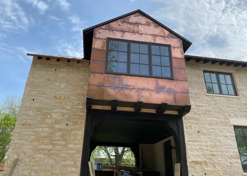 Copper metal panel facade on a stone building for Skylight Installation in Sweetwater